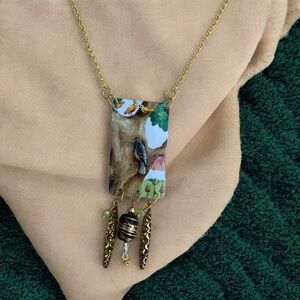 Mixed media artisan necklace. Made from a toffee tin. Woodpecker and birds.